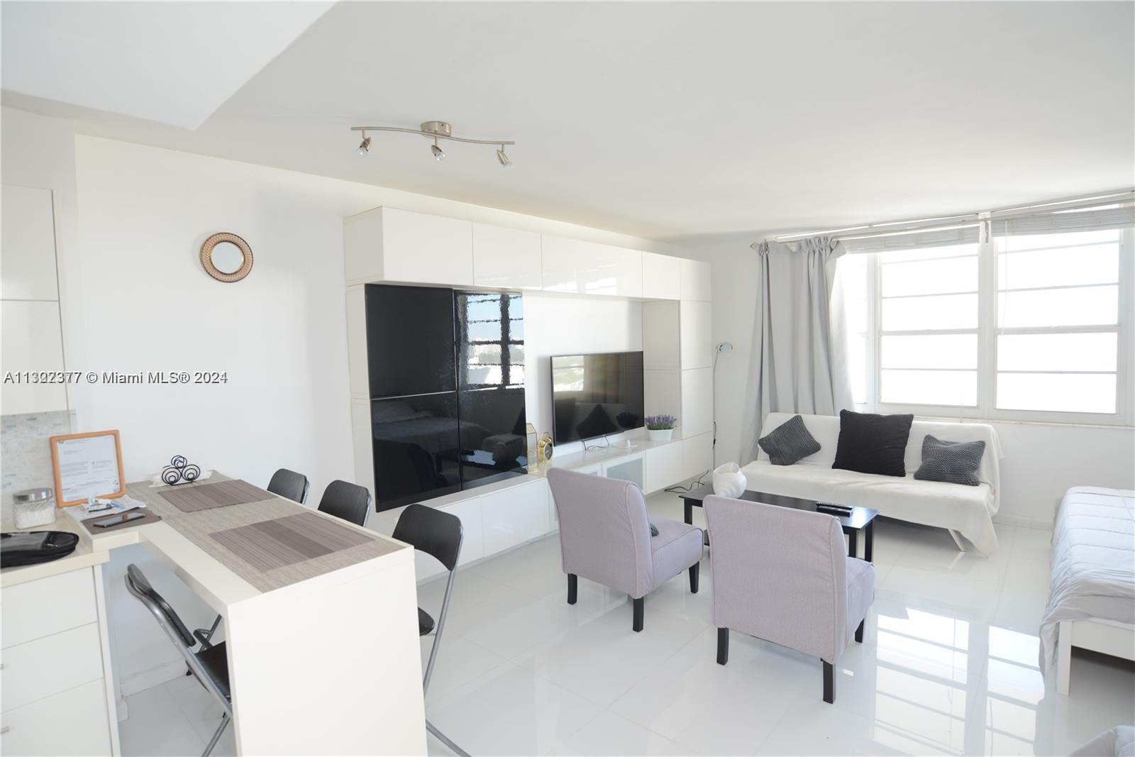 100 Lincoln Road, Unit 1605 Miami Beach, FL 33139 - Photo 2 of 20 a living room with furniture and a flat screen tv