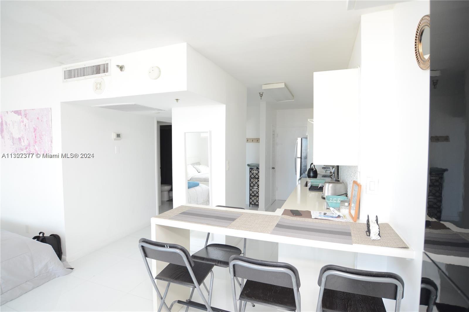 100 Lincoln Road, Unit 1605 Miami Beach, FL 33139 - Photo 6 of 20 a dining room with furniture and window