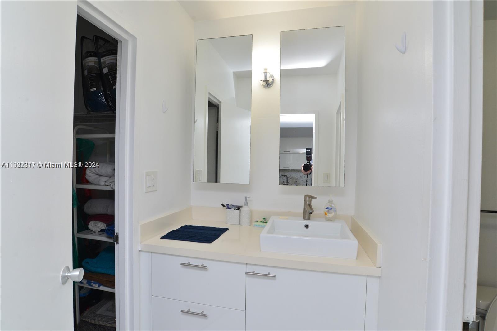 100 Lincoln Road, Unit 1605 Miami Beach, FL 33139 - Photo 10 of 20 a bathroom with a sink and a mirror