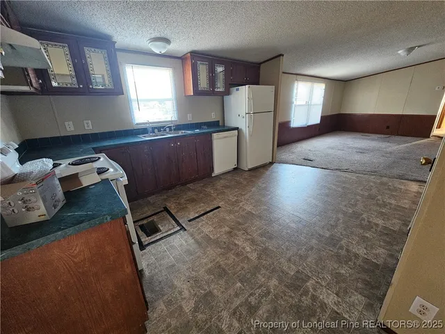 a kitchen with refrigerator and window