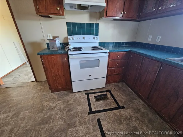 a kitchen with a stove and cabinets
