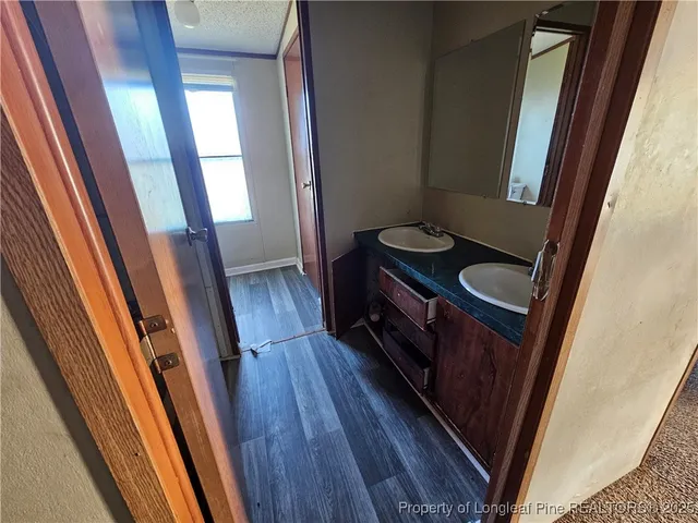 a view of a closet and wooden floor