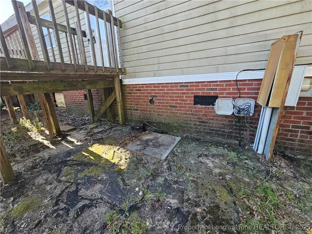 a view of a backyard with a table and chair under an umbrella