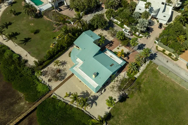 an aerial view of residential houses with outdoor space and lake view