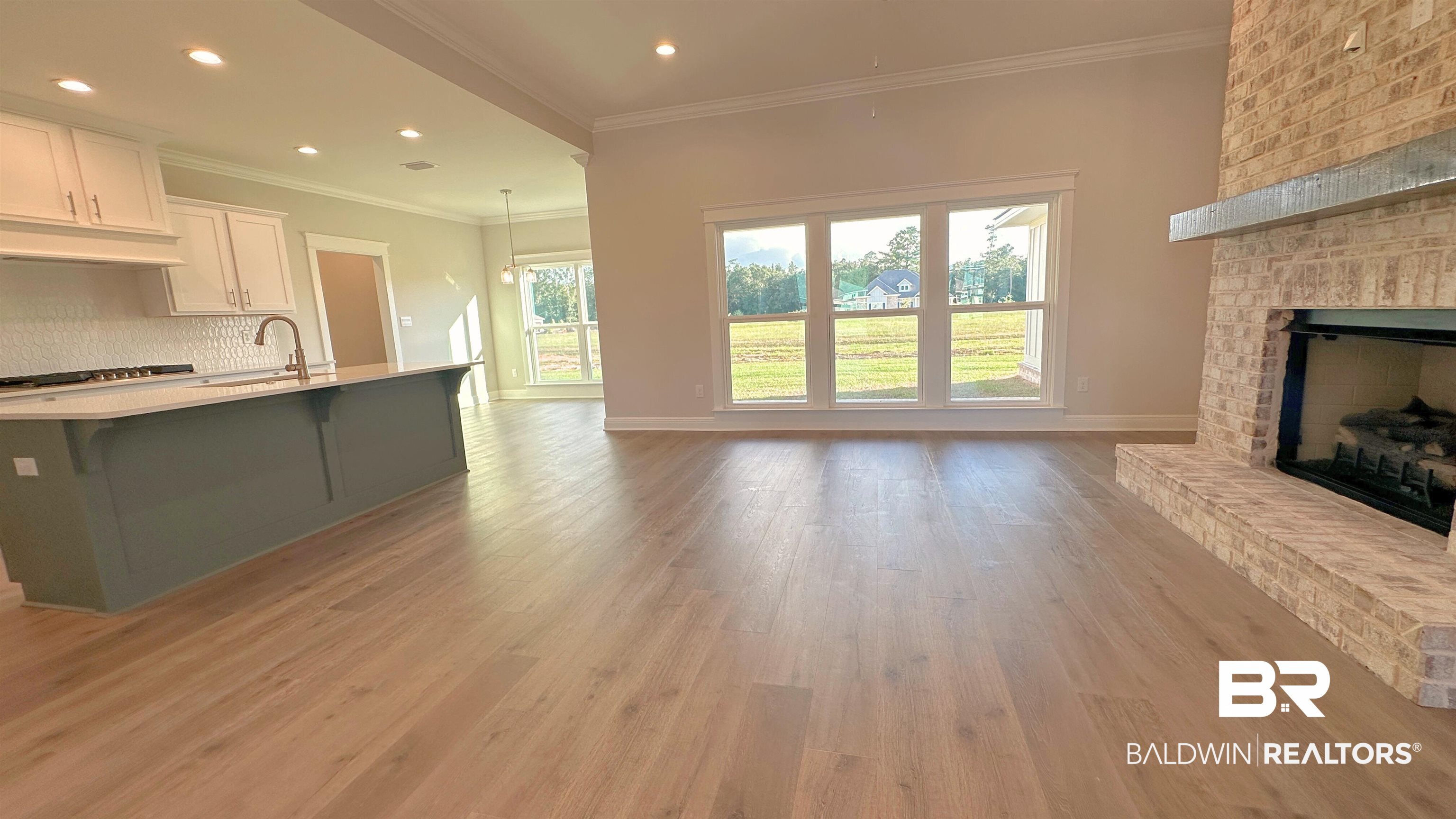 126 Daybreak Trail Fairhope, AL 36532 - Photo 7 of 34 Unfurnished living room with ornamental molding, a fireplace, light wood finished floors, and recessed lighting