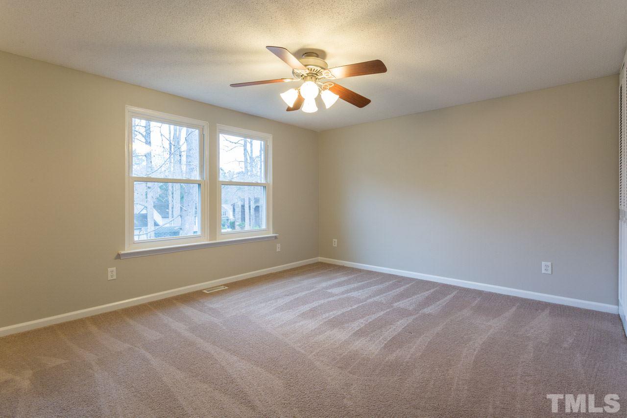 1232 Nikole Court Raleigh, NC 27612 - Photo 14 of 30 a view of an empty room with window and chandelier fan