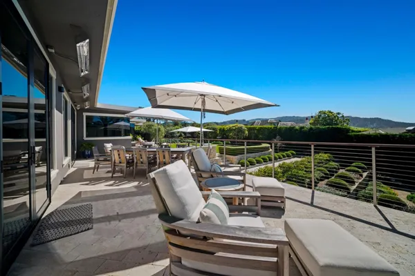 a view of chairs and tables in the balcony
