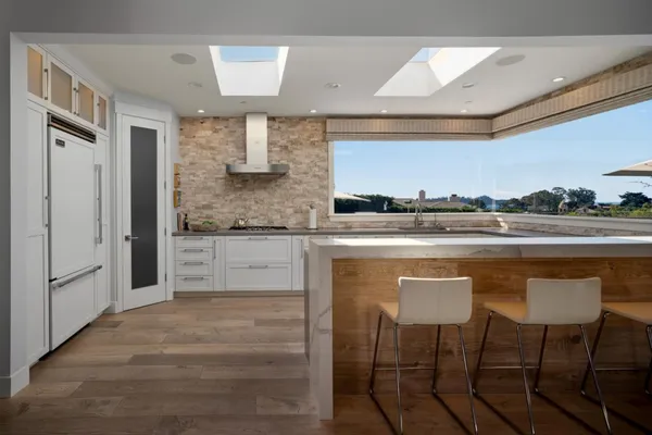 a kitchen with stainless steel appliances granite countertop a sink and cabinets