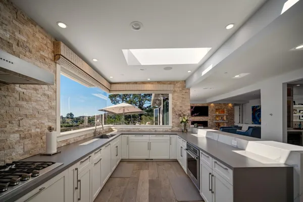 a kitchen with stainless steel appliances a sink stove and cabinets