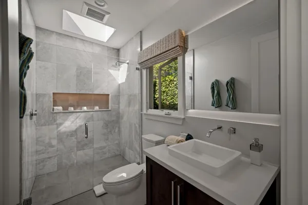 a bathroom with a sink toilet and shower
