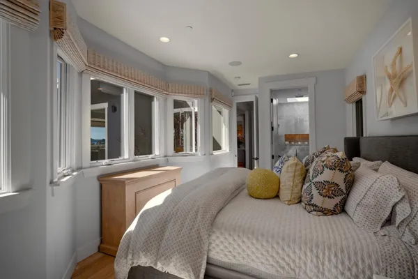 a bedroom with a bed and glass windows