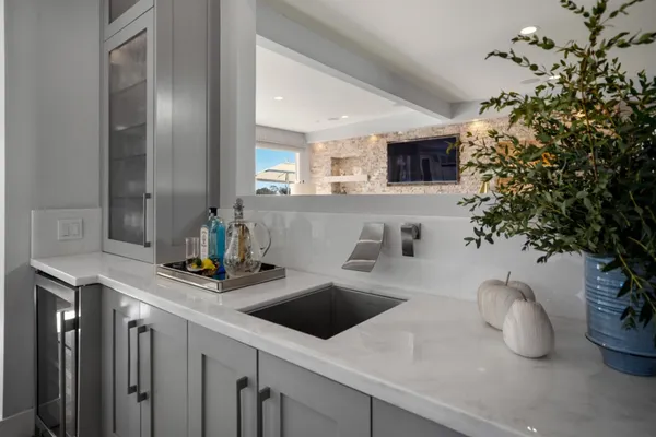 a kitchen with a sink a counter space and cabinets