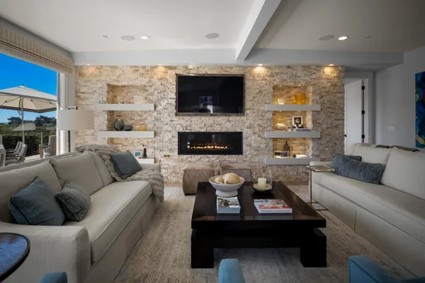 a living room with furniture flat screen tv and a fireplace