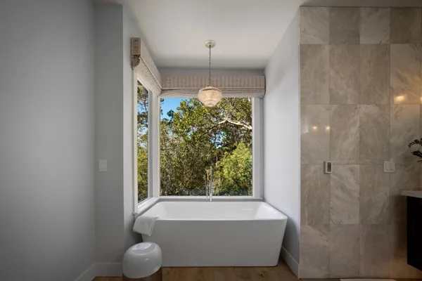 a bathroom with a bathtub and window