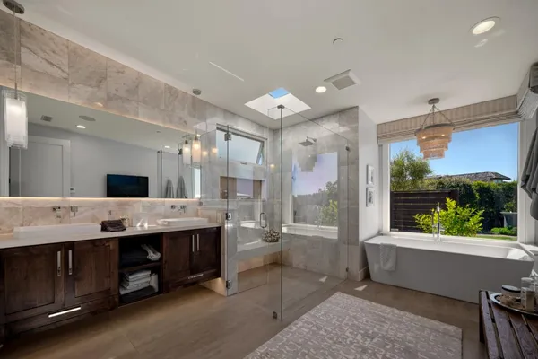 a large bathroom with a large tub and sink