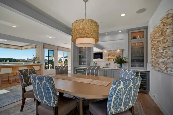 a dining room with furniture window and wooden floor
