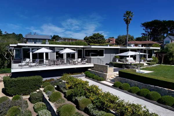 a front view of a house with a garden