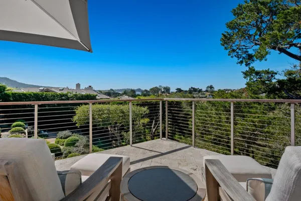 a balcony with table and chairs