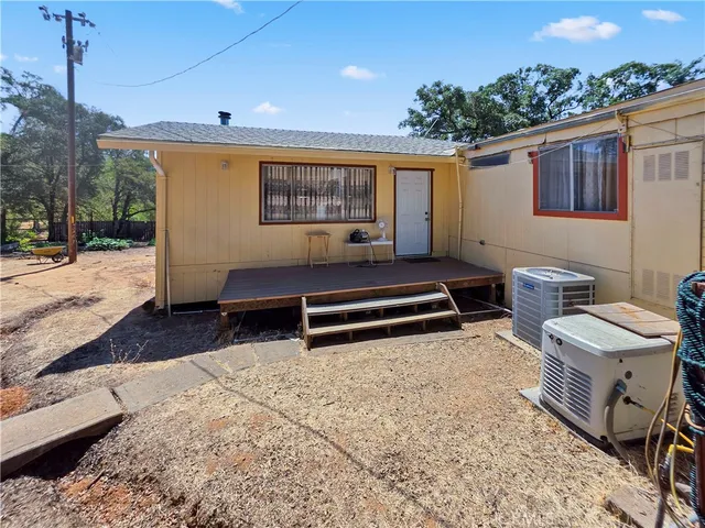 a backyard of a house with barbeque oven and outdoor seating