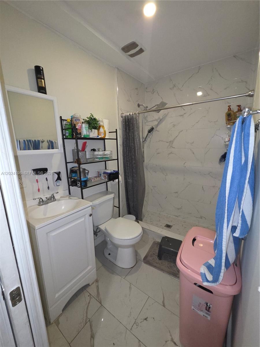 651 East 48th Street Hialeah, FL 33013 - Photo 42 of 52 a bathroom with a sink a toilet and shower