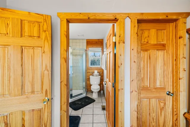 a view of a bathroom with a shower and a door