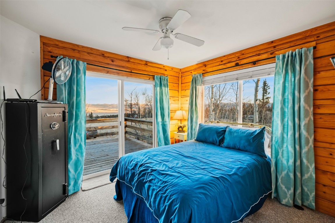 1026 Warpath Road Como, CO 80456 - Photo 19 of 45 a bedroom with a large bed and a chandelier