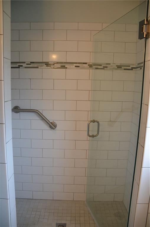 315 Quail Ridge Court Gibsonia, PA 15044 - Photo 14 of 25 The shower in the master bath also features subway tile, mosaic tile floor, glass door and a safety grab bar.