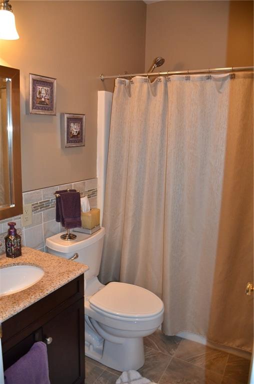 315 Quail Ridge Court Gibsonia, PA 15044 - Photo 18 of 25 The hall guest bath features a high end vinyl floor, tile half wall, fiberglass tub/shower surround and solid surface vanity top.