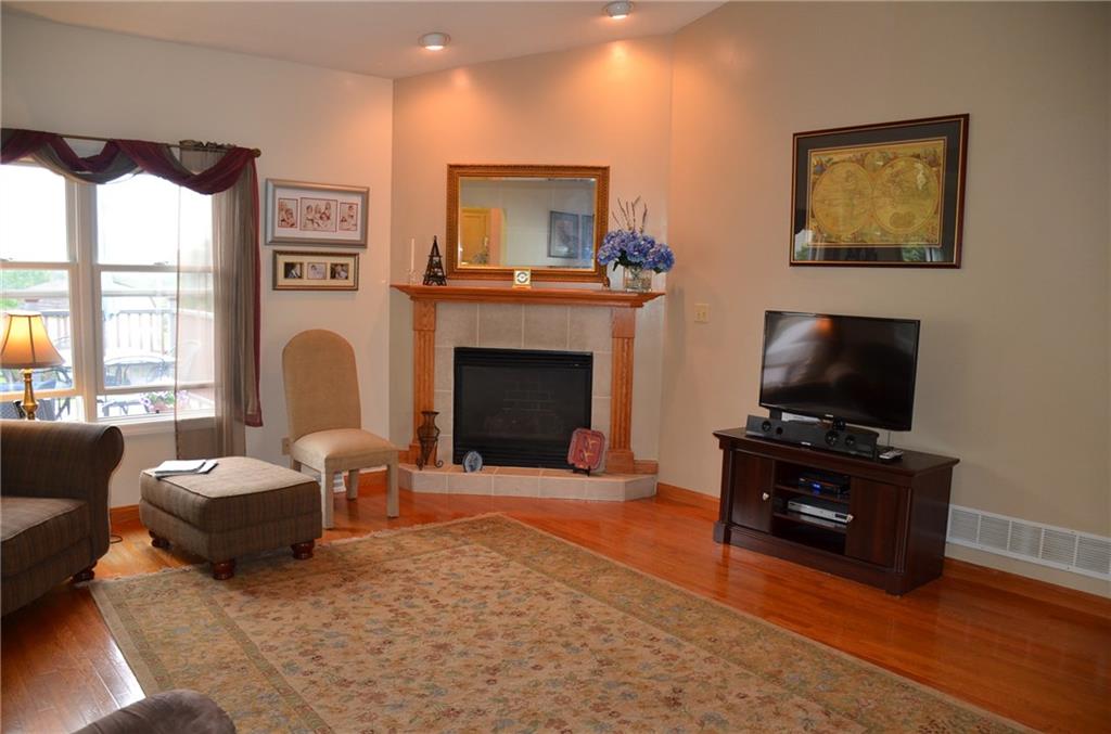 315 Quail Ridge Court Gibsonia, PA 15044 - Photo 5 of 25 The spacious living room/great room features hardwood floors, a gas fireplace, recessed lighting and tons of natural light.
