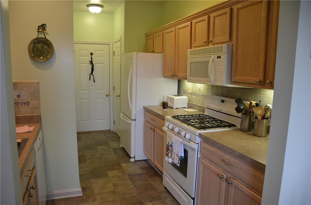 315 Quail Ridge Court Gibsonia, PA 15044 - Photo 8 of 25 The fully equipped kitchen comes with all appliances, tile backsplash, high end vinyl floor and a full size pantry next to the fridge.
