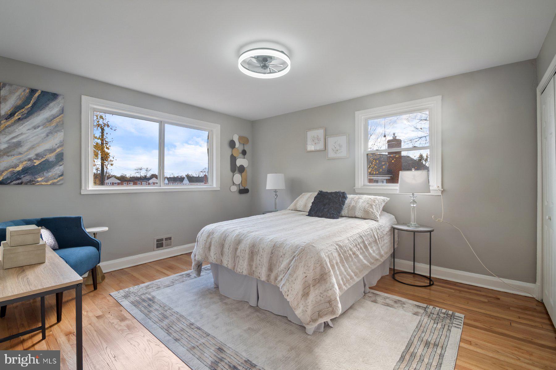 4801 Sinclair Lane Baltimore, MD 21206 - Photo 14 of 28 a bedroom with a bed and wooden floor