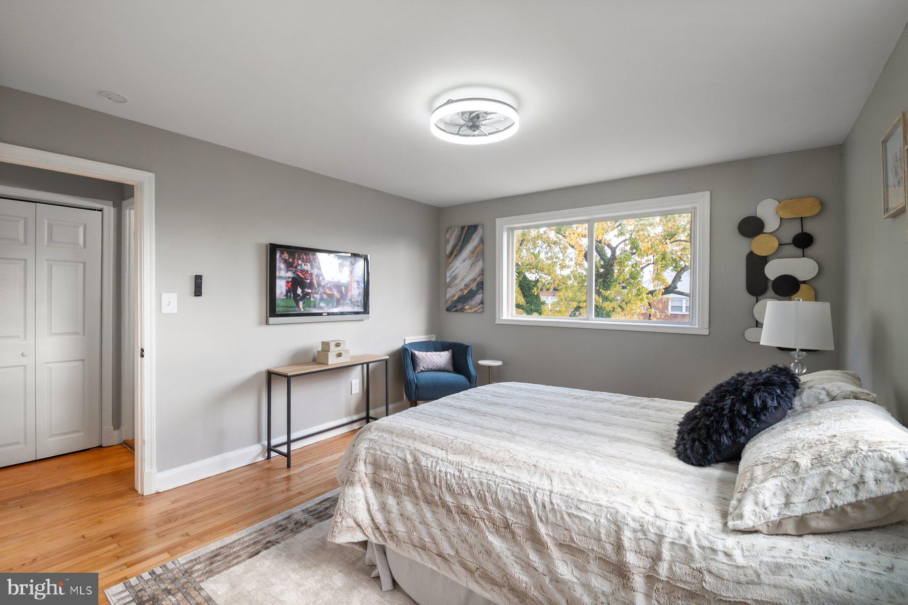 4801 Sinclair Lane Baltimore, MD 21206 - Photo 15 of 28 a bedroom with a bed and a chandelier