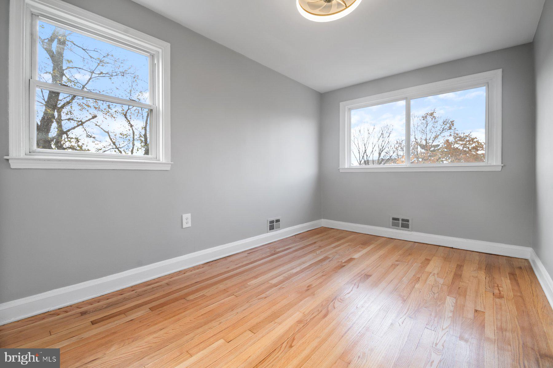 4801 Sinclair Lane Baltimore, MD 21206 - Photo 17 of 28 a view of empty room with wooden floor and fan