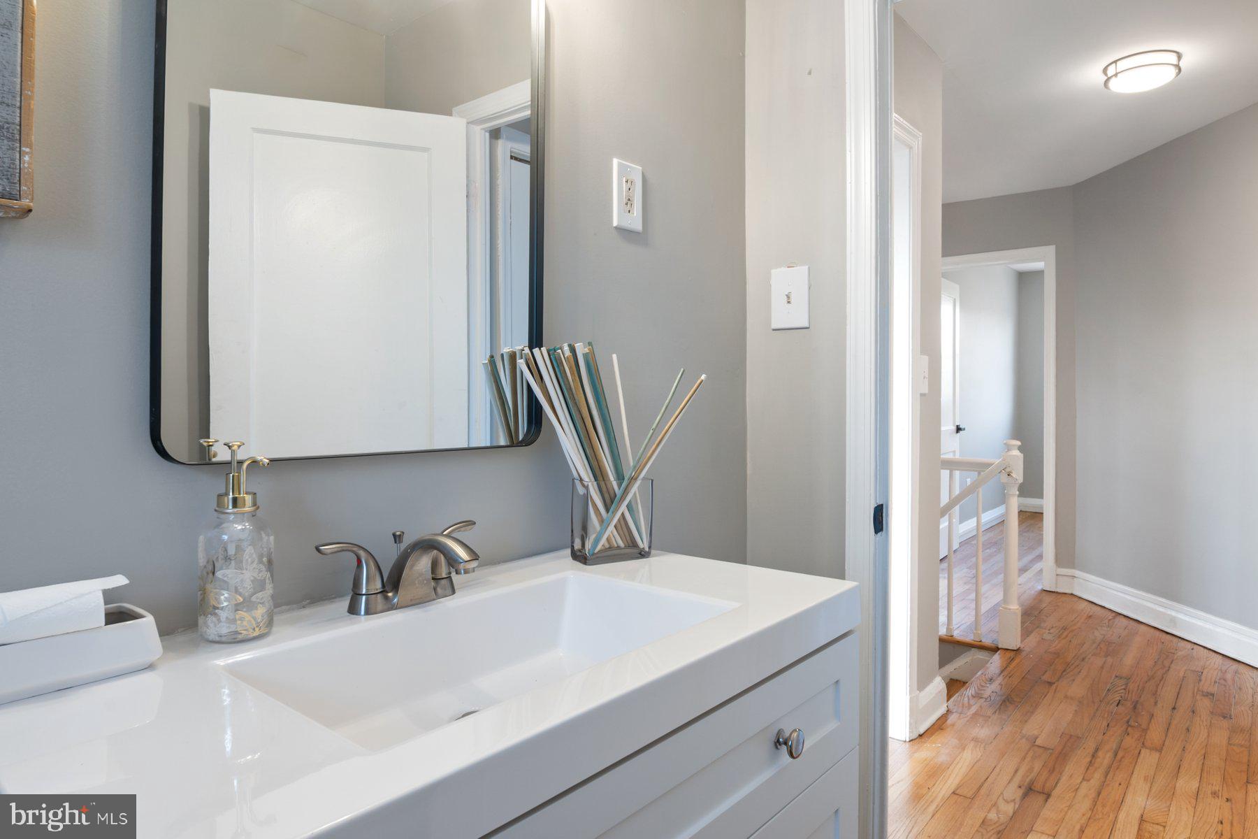 4801 Sinclair Lane Baltimore, MD 21206 - Photo 20 of 28 a bathroom with a sink and a mirror