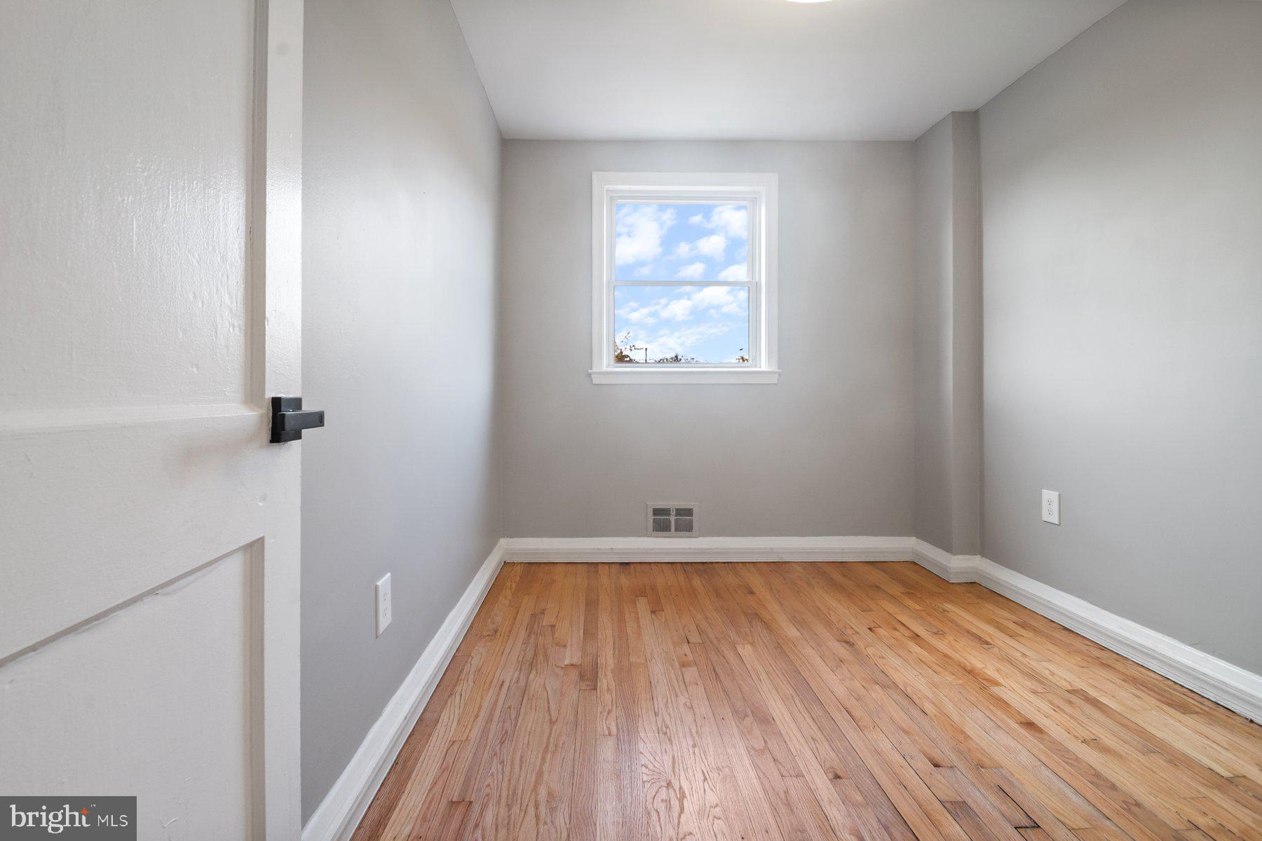 4801 Sinclair Lane Baltimore, MD 21206 - Photo 21 of 28 wooden floor in an empty room with a window