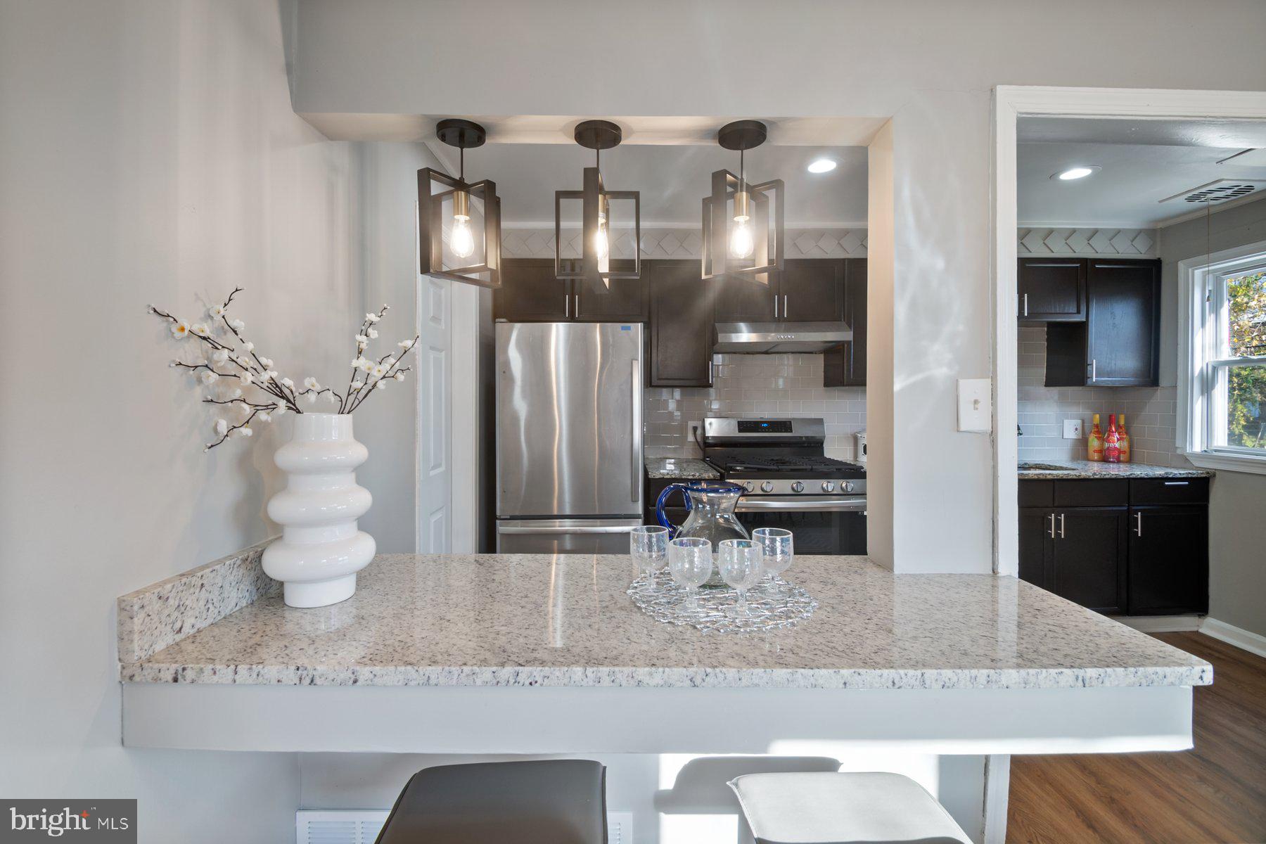 4801 Sinclair Lane Baltimore, MD 21206 - Photo 9 of 28 a kitchen with a refrigerator and a sink