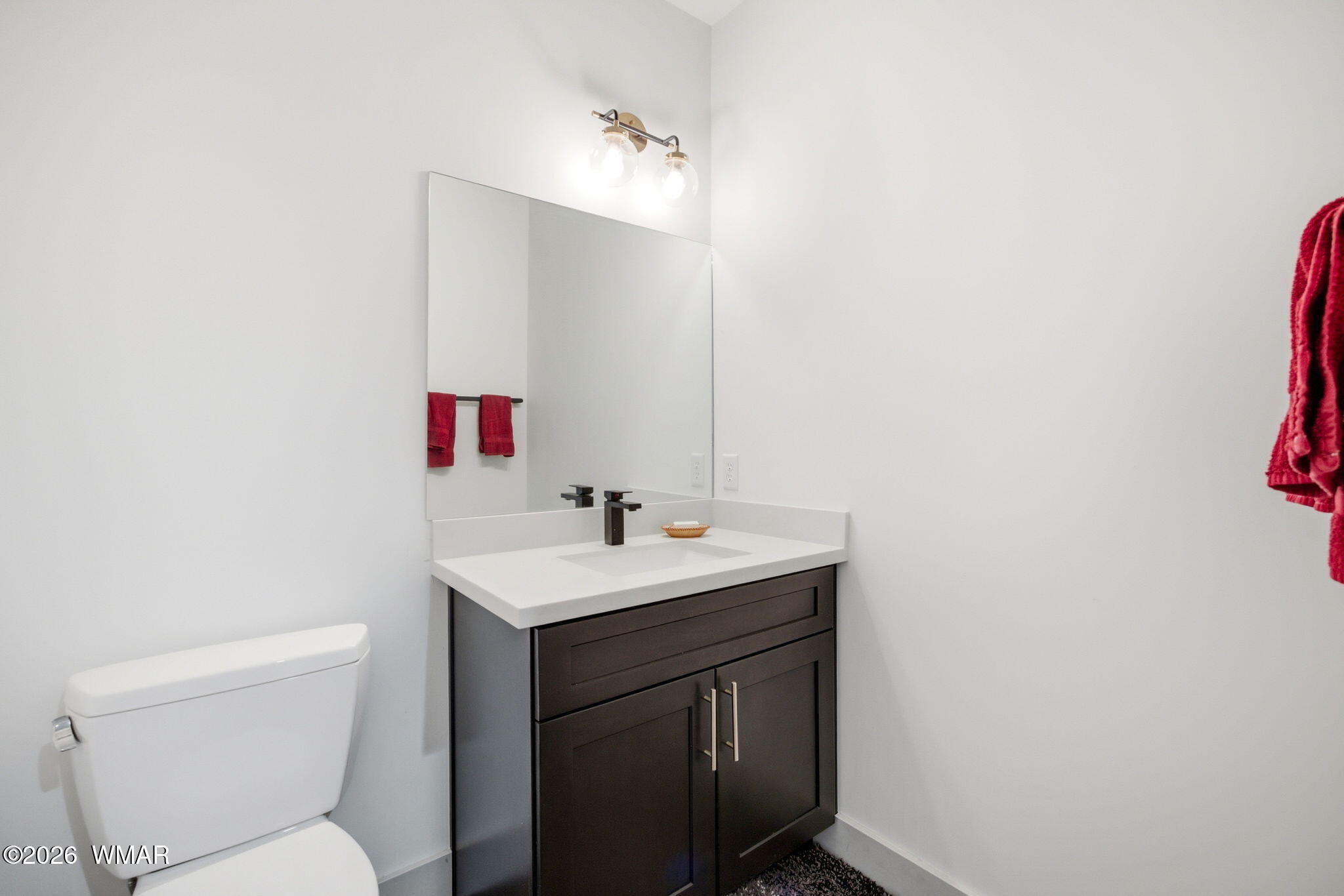 1852 West 7th S Street Snowflake, AZ 85937 - Photo 19 of 37 a bathroom with a toilet sink and mirror
