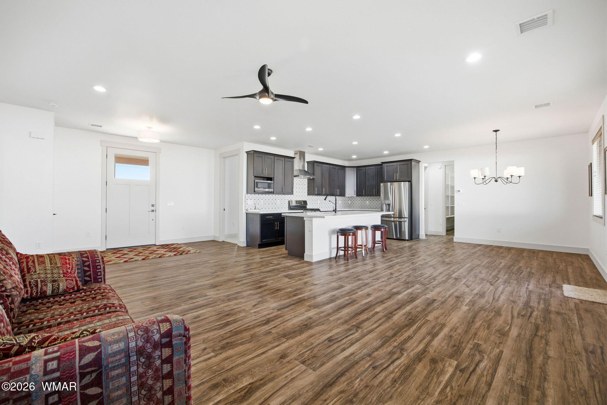 1852 West 7th S Street Snowflake, AZ 85937 - Photo 7 of 37 a living room with stainless steel appliances kitchen island furniture and wooden floor