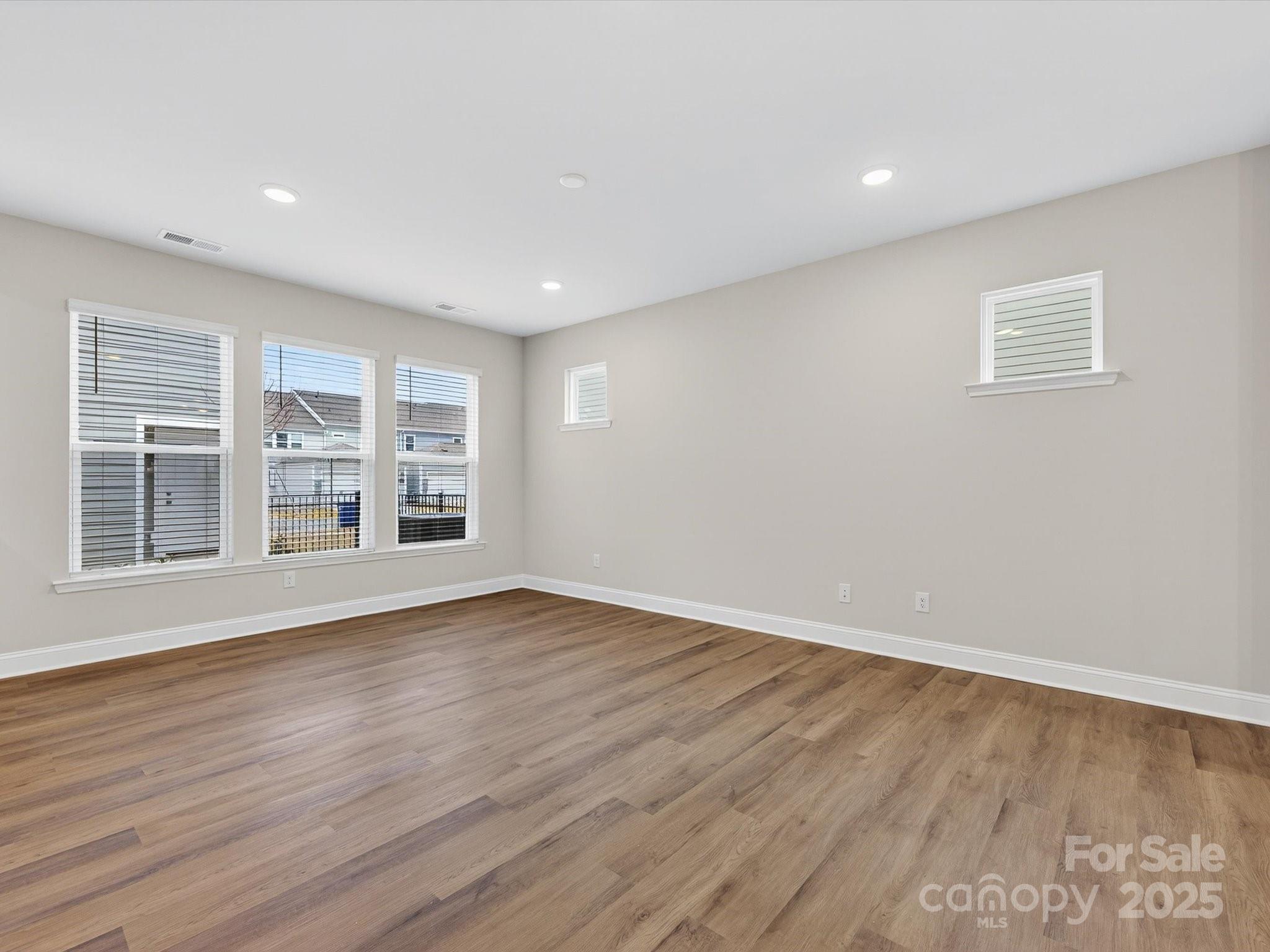 11445 Prosperity Church Road Huntersville, NC 28078 - Photo 12 of 35 a view of an empty room with wooden floor and a window
