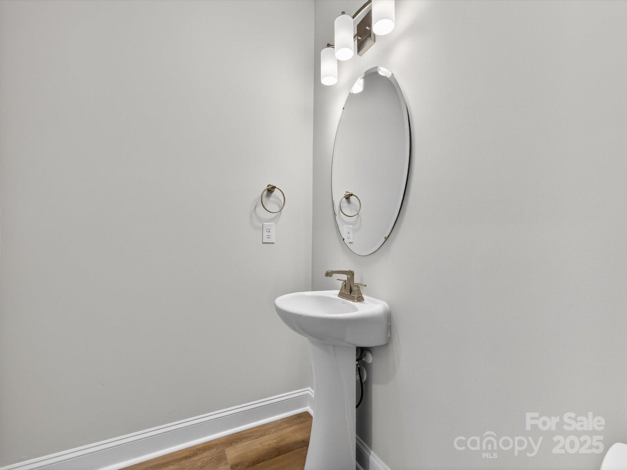 11445 Prosperity Church Road Huntersville, NC 28078 - Photo 16 of 35 a bathroom with a sink a mirror and toilet