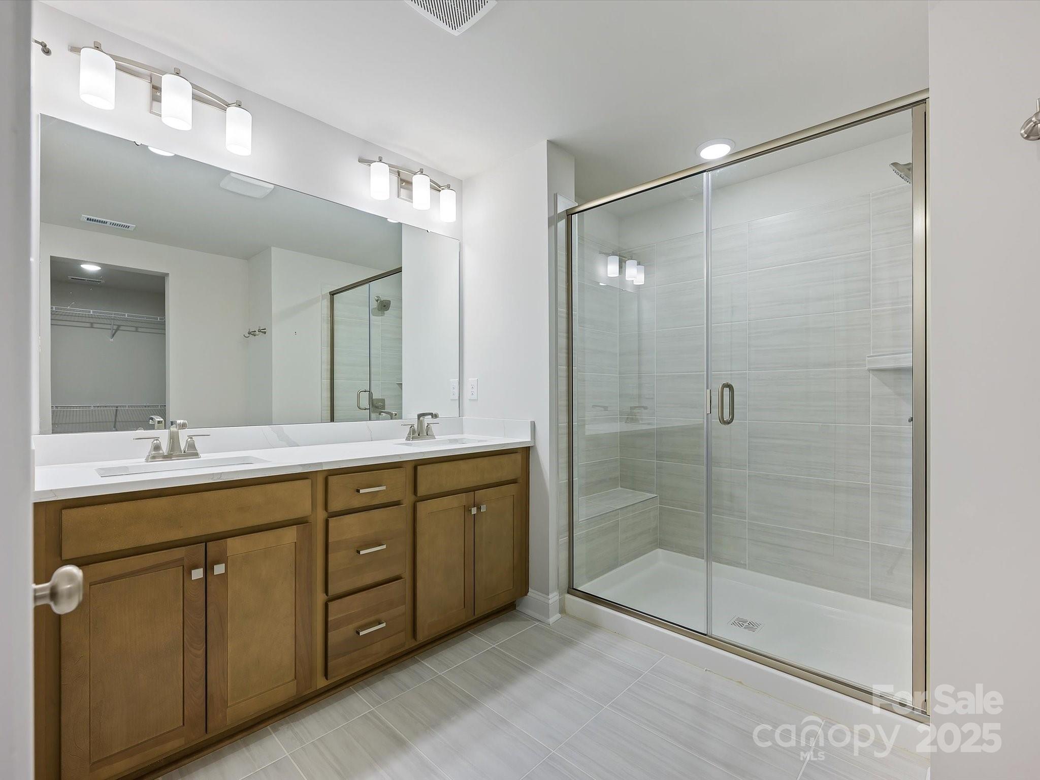 11445 Prosperity Church Road Huntersville, NC 28078 - Photo 20 of 35 a bathroom with a shower sink and mirror