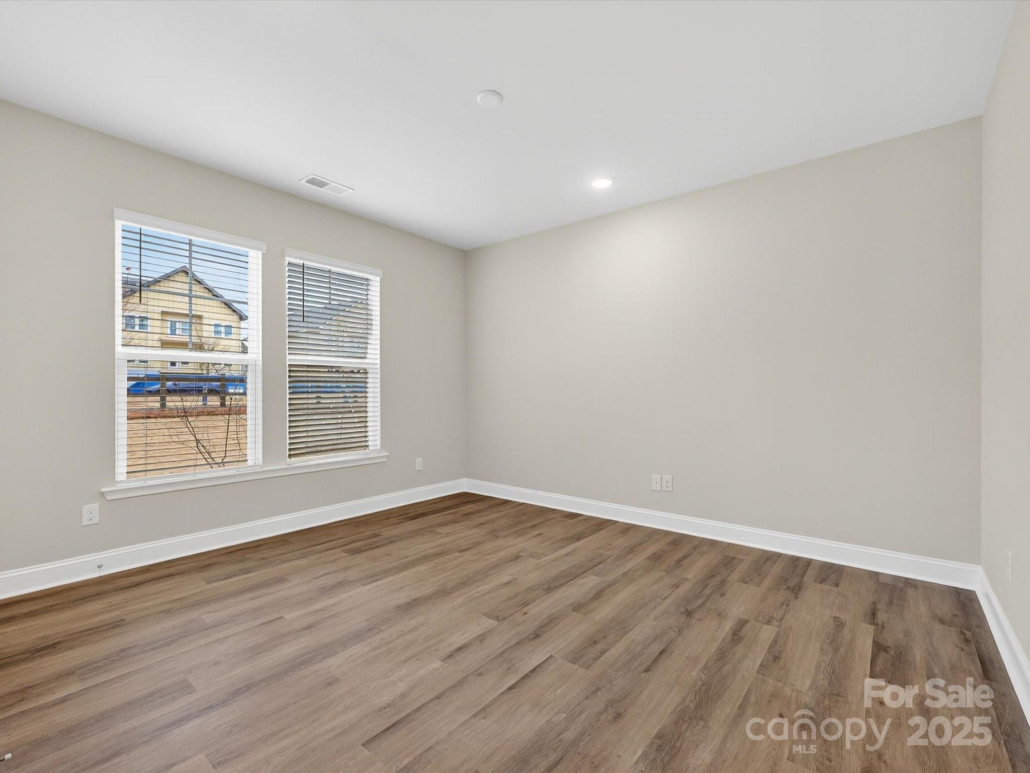11445 Prosperity Church Road Huntersville, NC 28078 - Photo 5 of 35 an empty room with wooden floor and windows