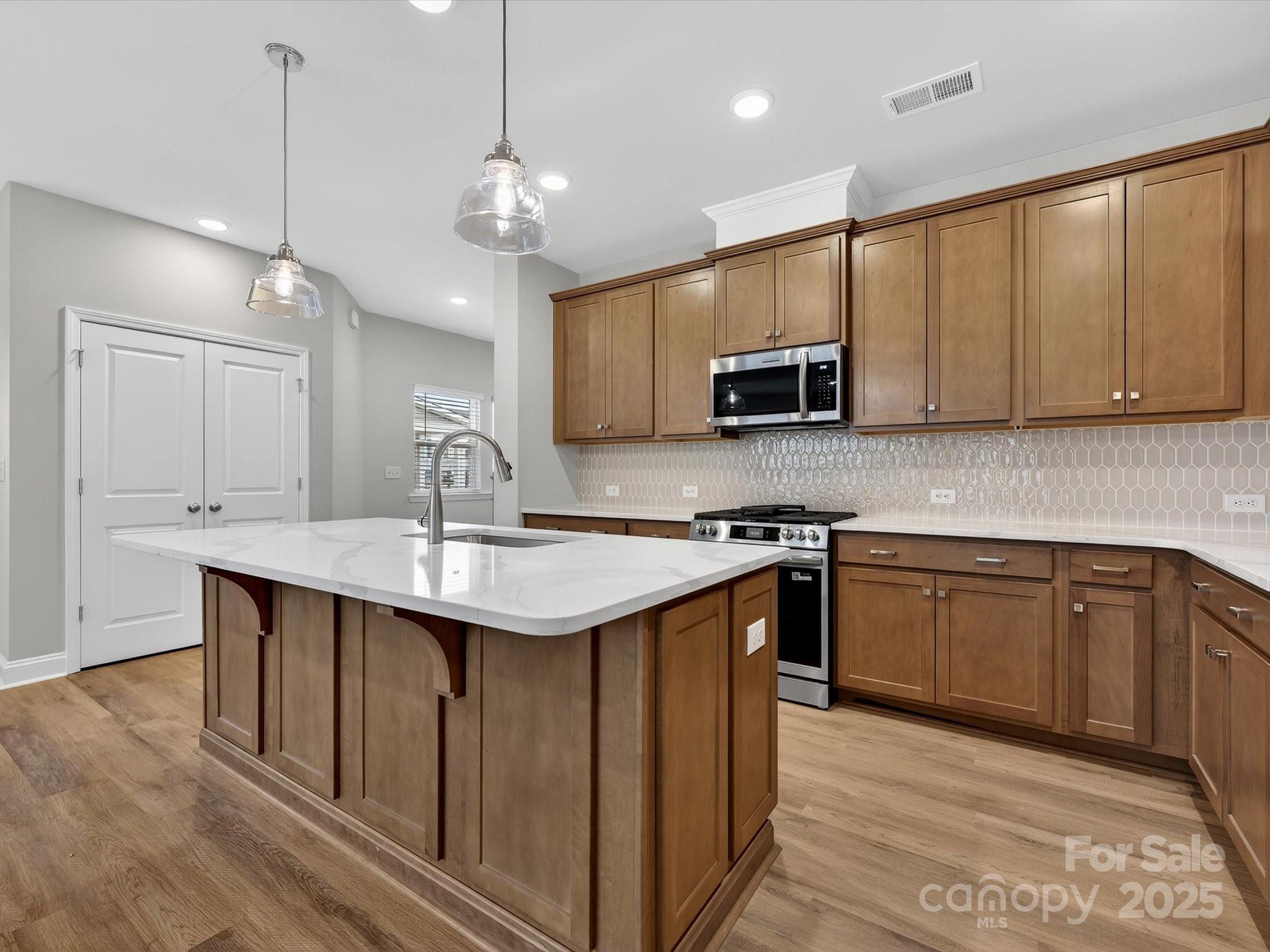 11445 Prosperity Church Road Huntersville, NC 28078 - Photo 8 of 35 a kitchen with kitchen island granite countertop a sink and microwave
