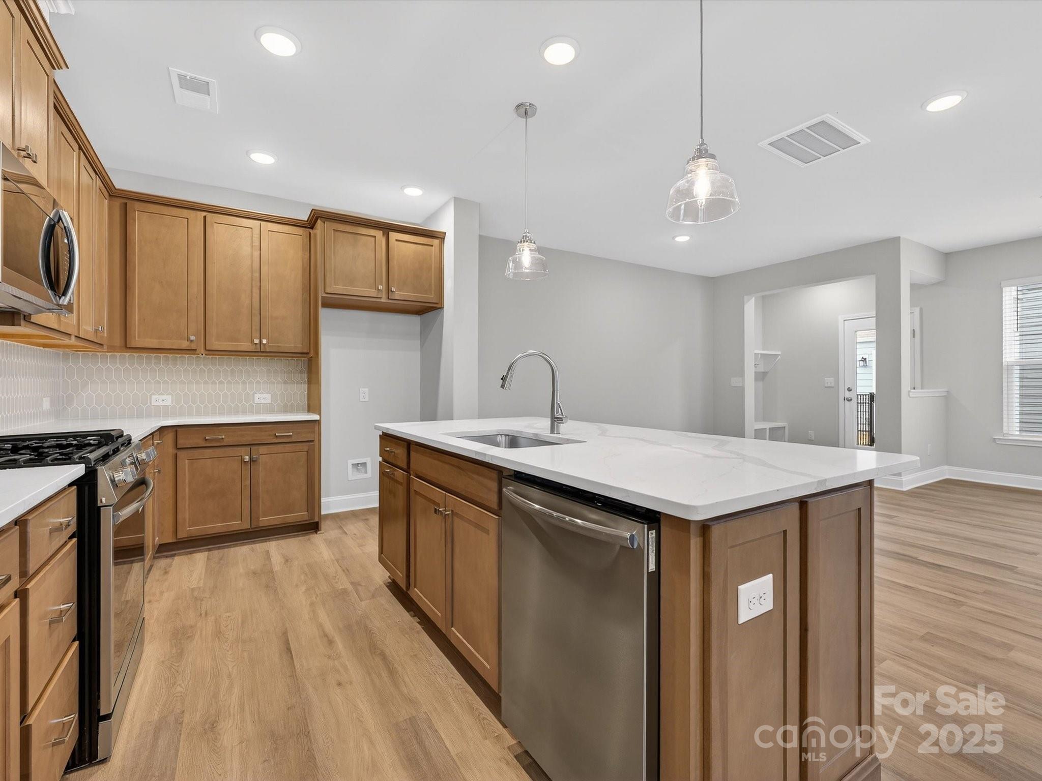 11445 Prosperity Church Road Huntersville, NC 28078 - Photo 10 of 35 a kitchen with a stove a sink and wooden floor