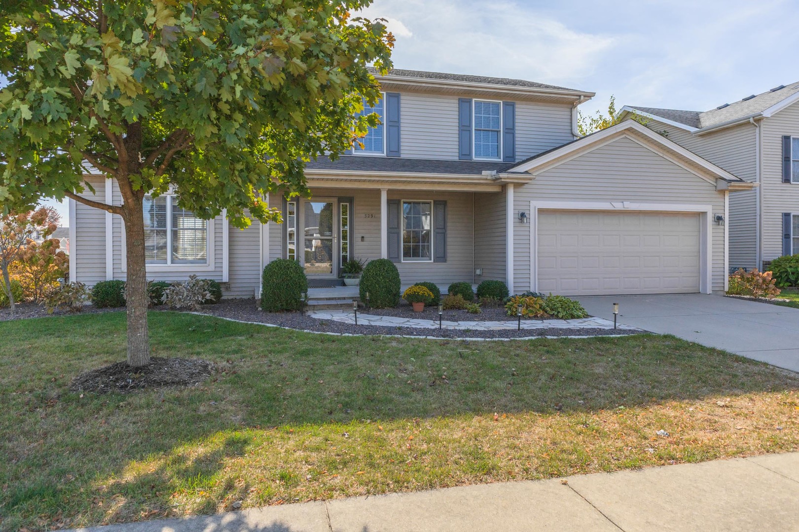 a front view of a house with garden and patio