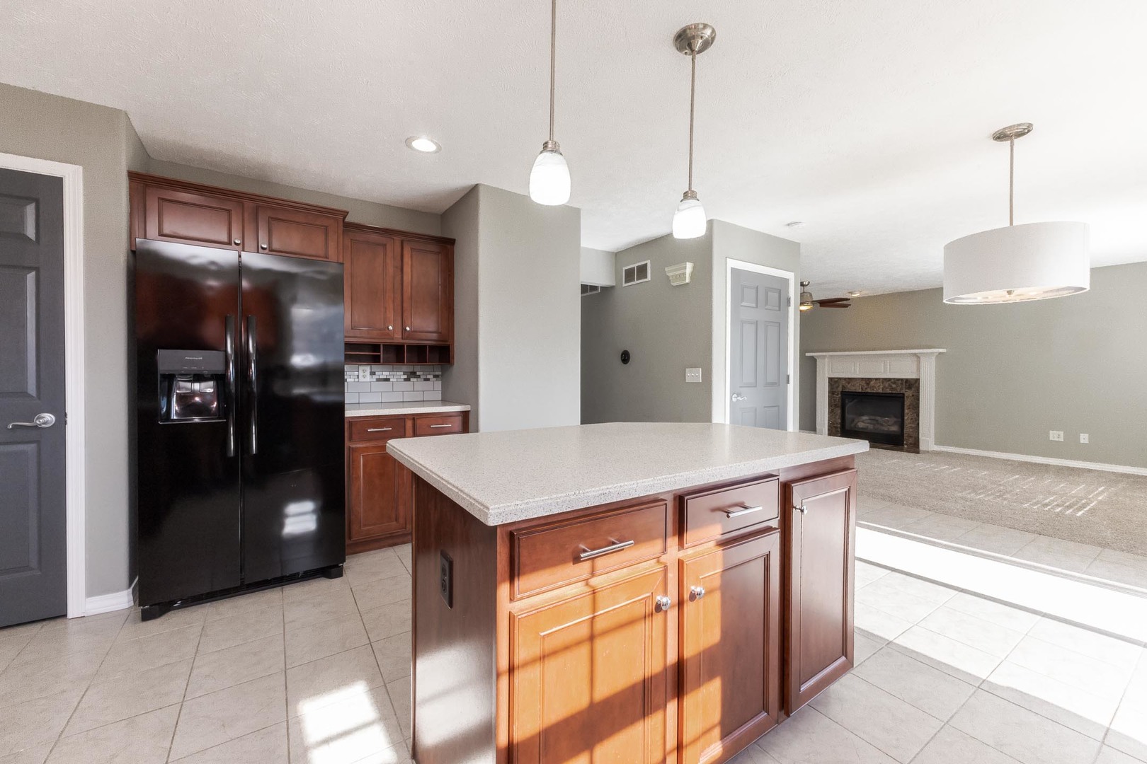 3291 Marimarsh Lane Normal, IL 61761 - Photo 25 of 55 a kitchen with kitchen island a counter space a refrigerator and a sink