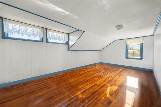 a bathroom with a granite countertop bathtub sink vanity mirror and toilet