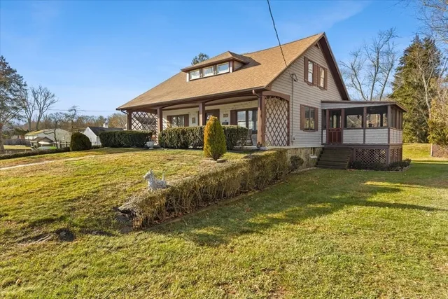 a front view of a house with yard and green space