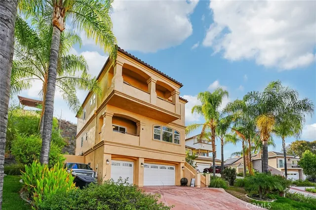 a front view of a house with a tree