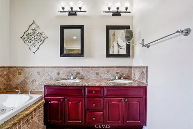 a spacious bathroom with a granite countertop sink a mirror and shower